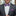 Man wearing a gray suit with a purple bow tie and pocket square.