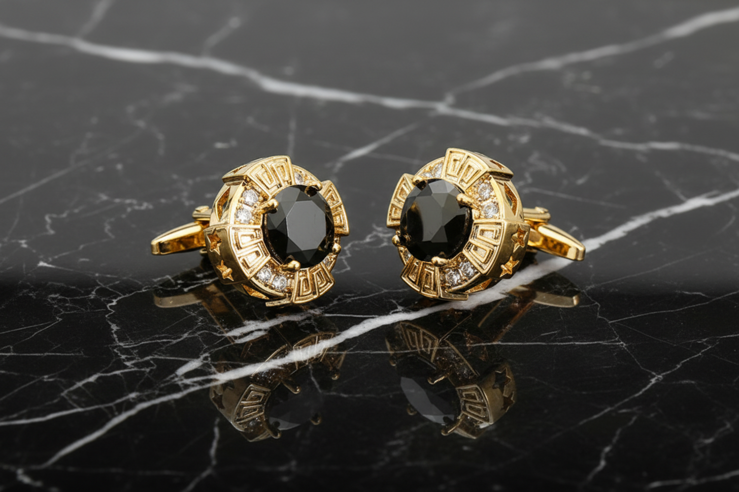 A pair of gold-colored circular cufflinks with red and clear stones set within.