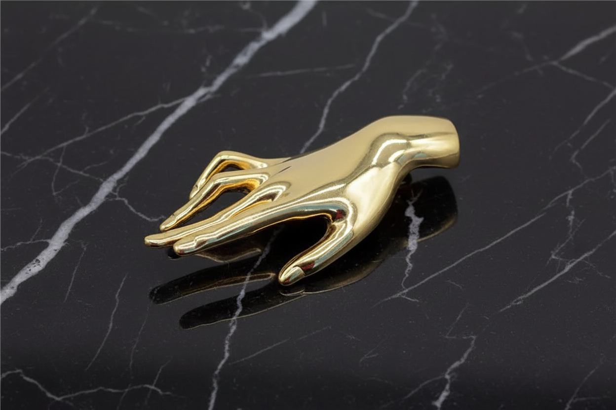 a gold hand lapel pin