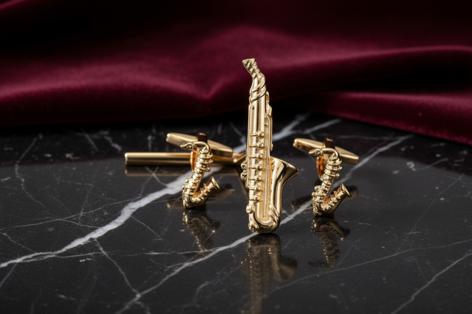 a gold tie clip and cufflinks