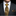 Man wearing a dark suit with a gold tie and pocket square on a black background