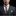 Man wearing a formal suit with a tie and pocket square on a black background