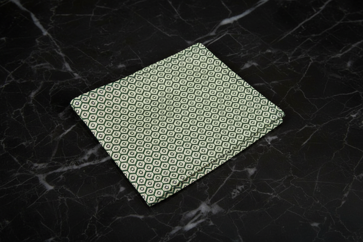 Green patterned card on a dark marble surface