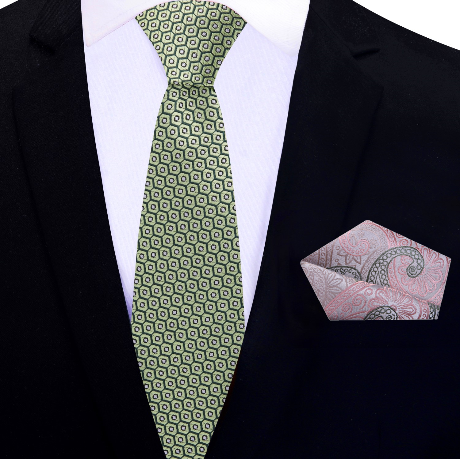 Green patterned thin tie and pink paisley pocket square on a black suit jacket.