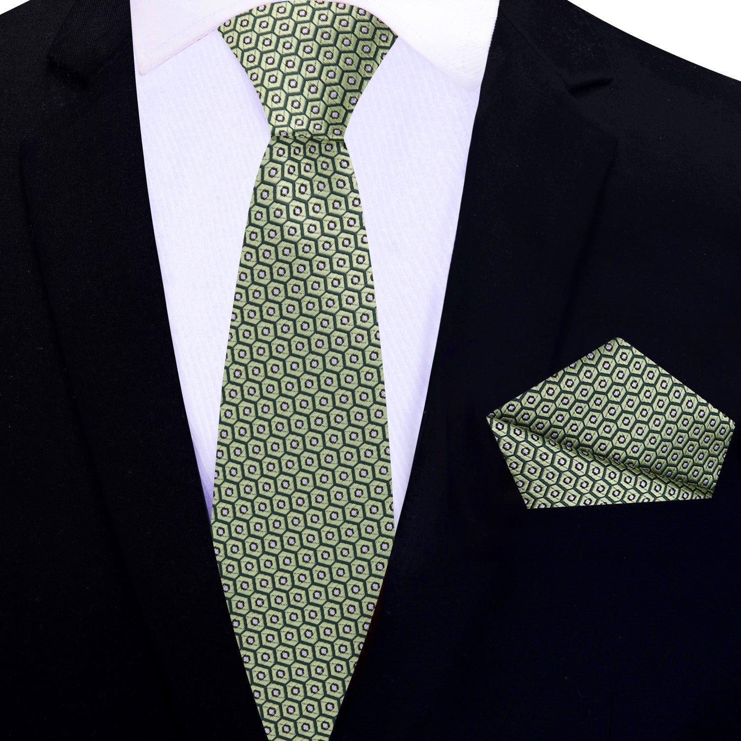 Green patterned thin tie and pocket square set on a black suit jacket.