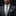 Man wearing a dark suit with a green patterned tie and pocket square against a black background