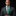 Man wearing a gray suit with a green tie and pocket square on a black background