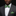 A man wearing a dark gray pinstripe suit, white dress shirt, and a green and black plaid bow tie with a matching pocket square, set against a solid black background.