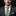 Man wearing a gray suit with a green polka dot tie and colorful pocket square on a black background