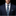 Man wearing a navy suit with a patterned tie and pocket square on a black background