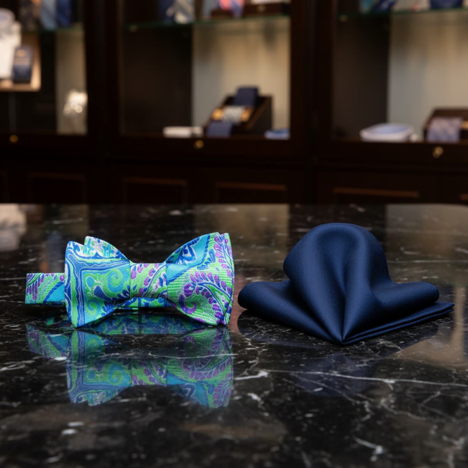 A Green, Blue And Purple Paisley Pattern Self Tie Bow Tie With Blue Pocket Square