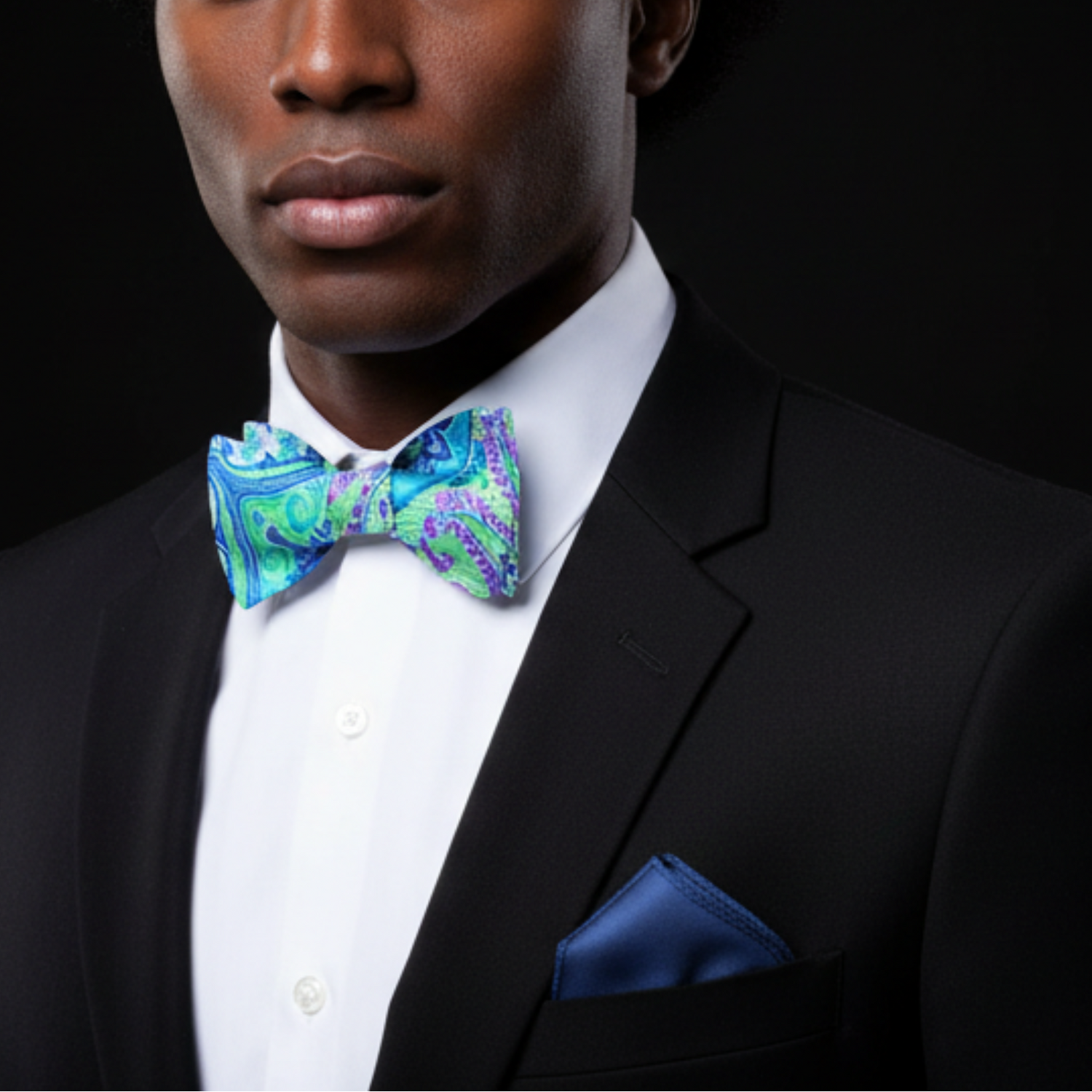 A Green, Blue And Purple Paisley Pattern Self Tie Bow Tie With Blue Pocket Square on man