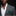 Man wearing a gray suit with a white shirt and striped green pocket square on a black background