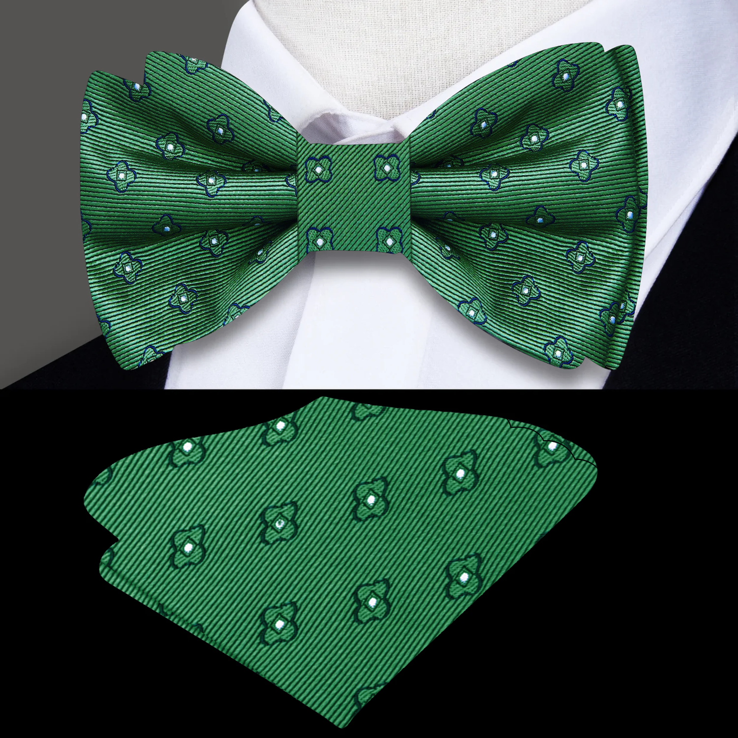 Green bow tie and matching pocket square on a white shirt with a gray background