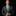 Man wearing a gray suit with a green tie and white shirt against a black background