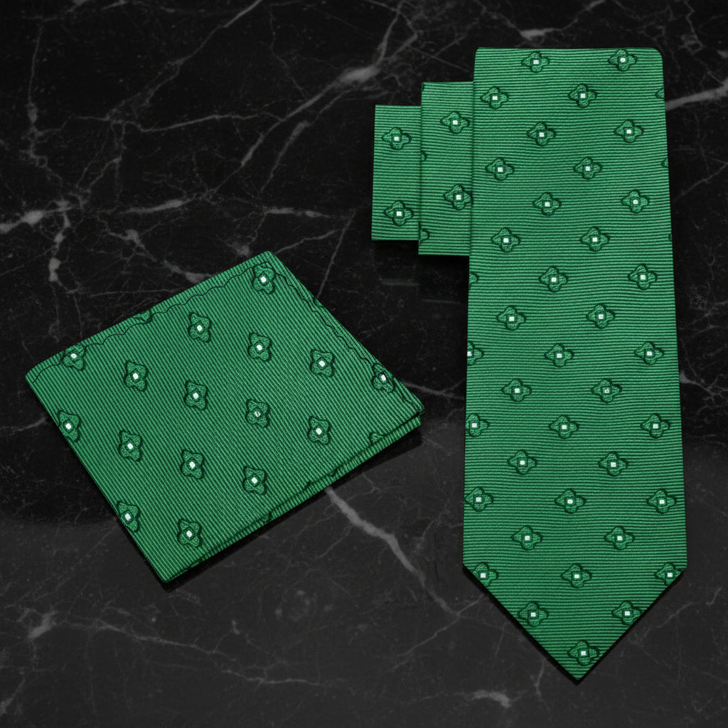 Green patterned tie and pocket square on a dark marble background