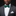 Man wearing a gray suit with a white shirt and green bow tie on a black background