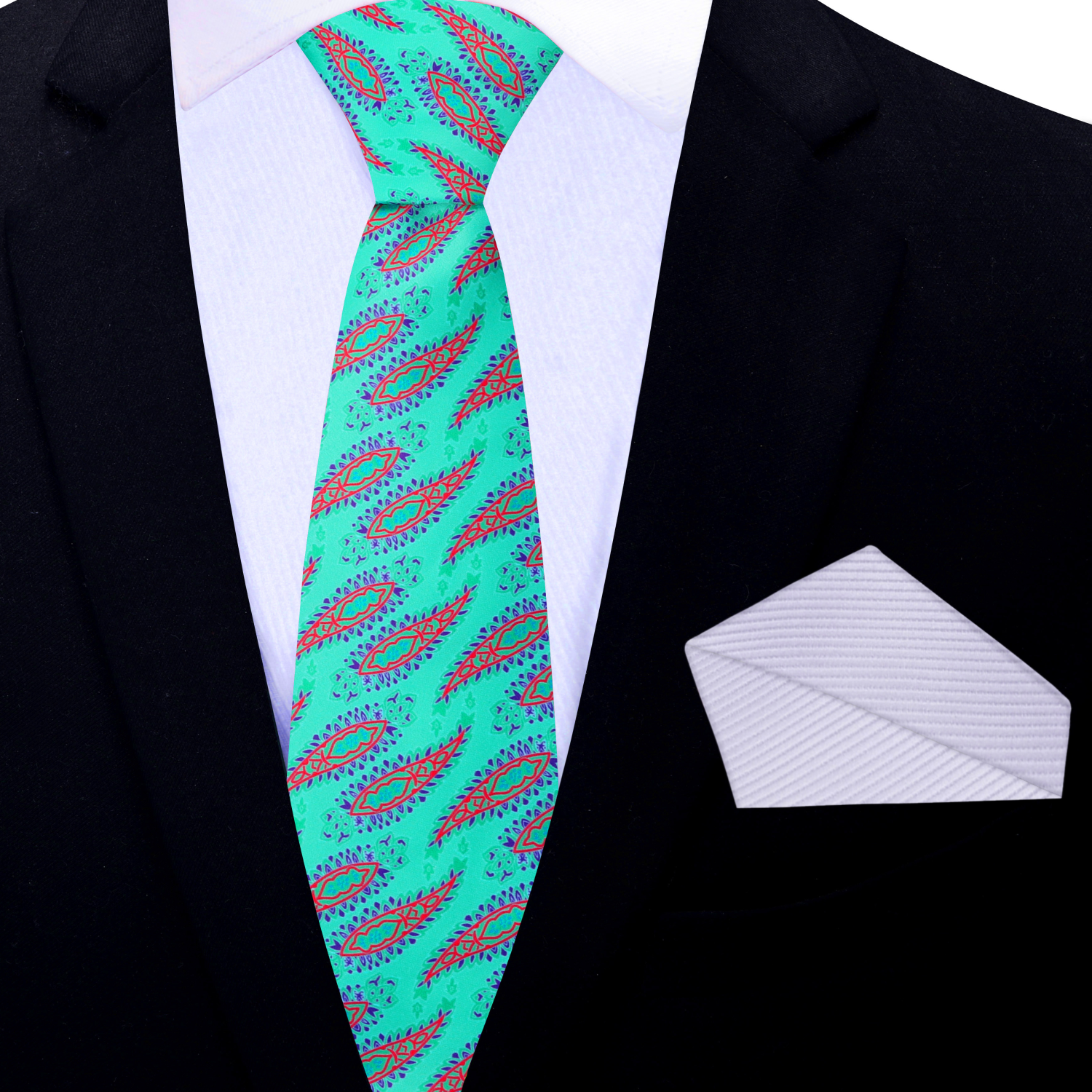 Green patterned tie with a white pocket square on a black suit jacket.