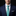 Man wearing a blue suit with a patterned green tie against a black background