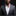 Man wearing a gray suit with a white shirt and patterned pocket square on a black background