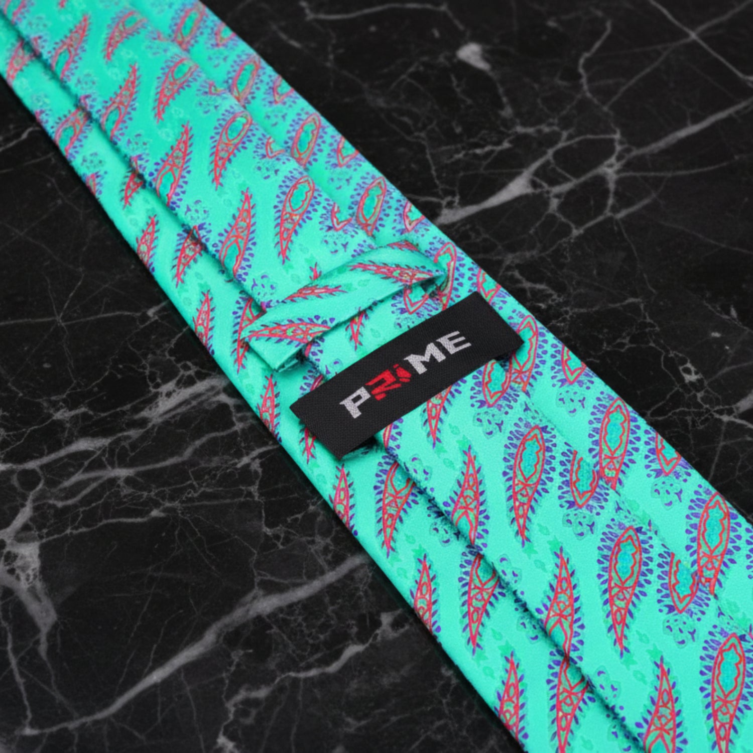 Teal tie with pink and purple pattern on a black marble background