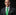 Man wearing a dark suit with a green tie and white shirt against a black background