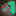 Green tie with penguin pattern and red and green patterned square on a wooden surface with Christmas decorations.