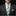 Man wearing a gray suit with a green and blue striped tie and matching pocket square.