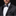 Man wearing a black tuxedo with a patterned bow tie and pocket square on a dark background
