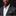 Man wearing a gray suit with a white shirt and patterned pocket square on a black background