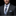 Man wearing a dark suit with a plaid tie and pocket square against a black background
