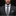 Man wearing a gray suit with a patterned tie and pocket square on a black background