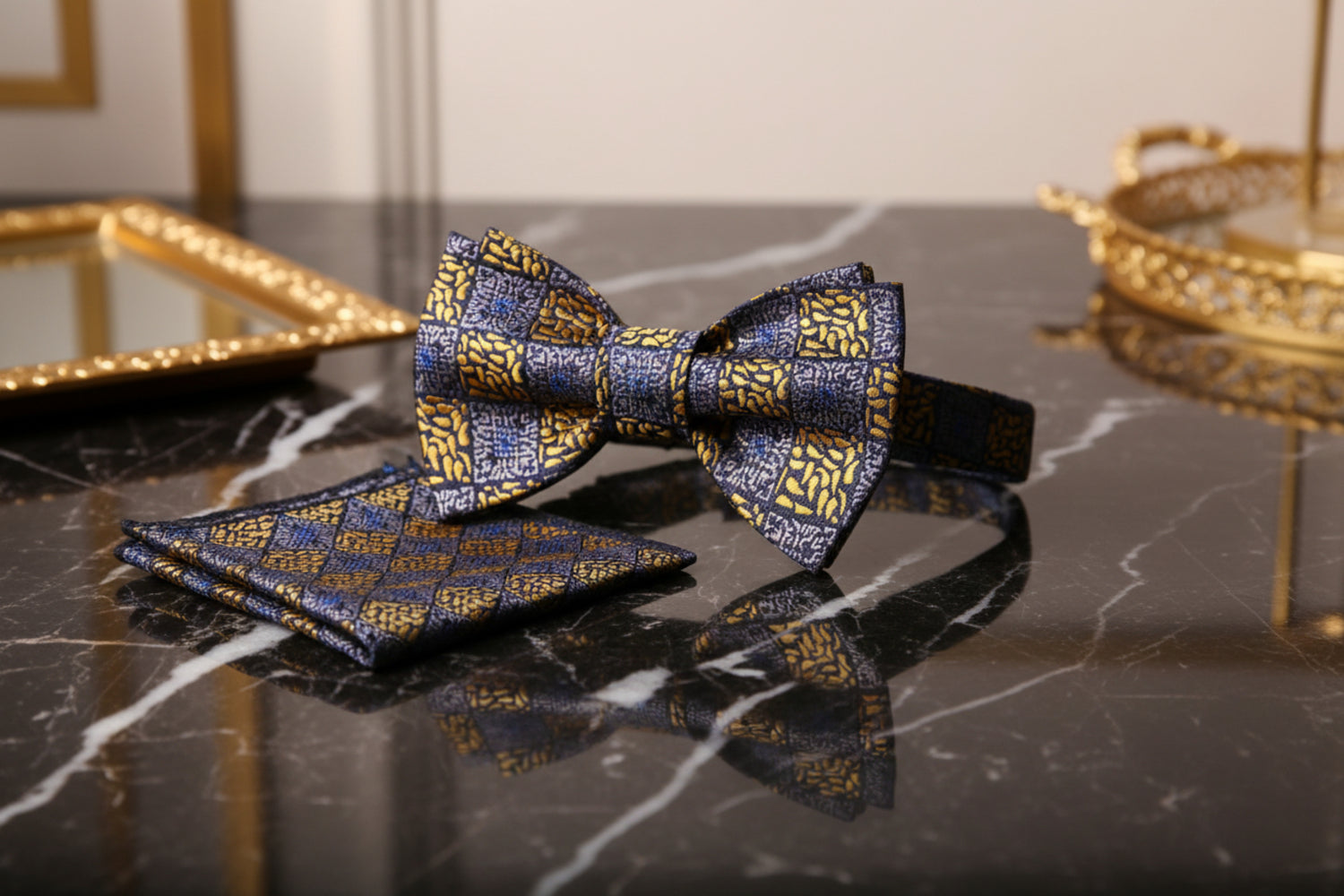 Patterned bow tie and pocket square set on a marble table