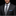 Man wearing a dark pinstripe suit with a gray plaid tie and blue handkerchief on a black background