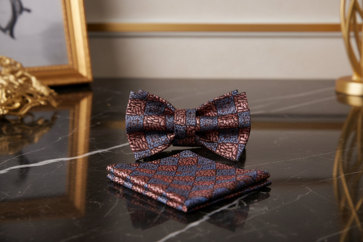 Patterned bow tie and pocket square set on a marble
