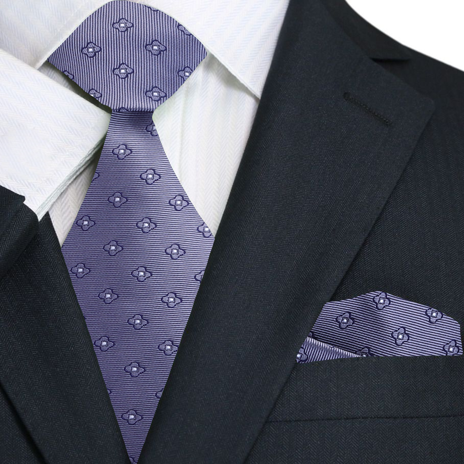 Black suit with white shirt, grey floral patterned tie, and matching pocket square.