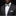 Man wearing a black suit with a floral bow tie and pocket square against a dark background