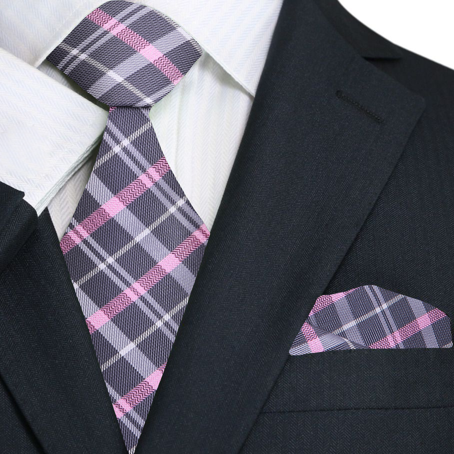 Black suit with a plaid tie and pocket square on a white background