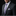 Man wearing a dark suit with a purple and gray plaid tie and pocket square on a black background