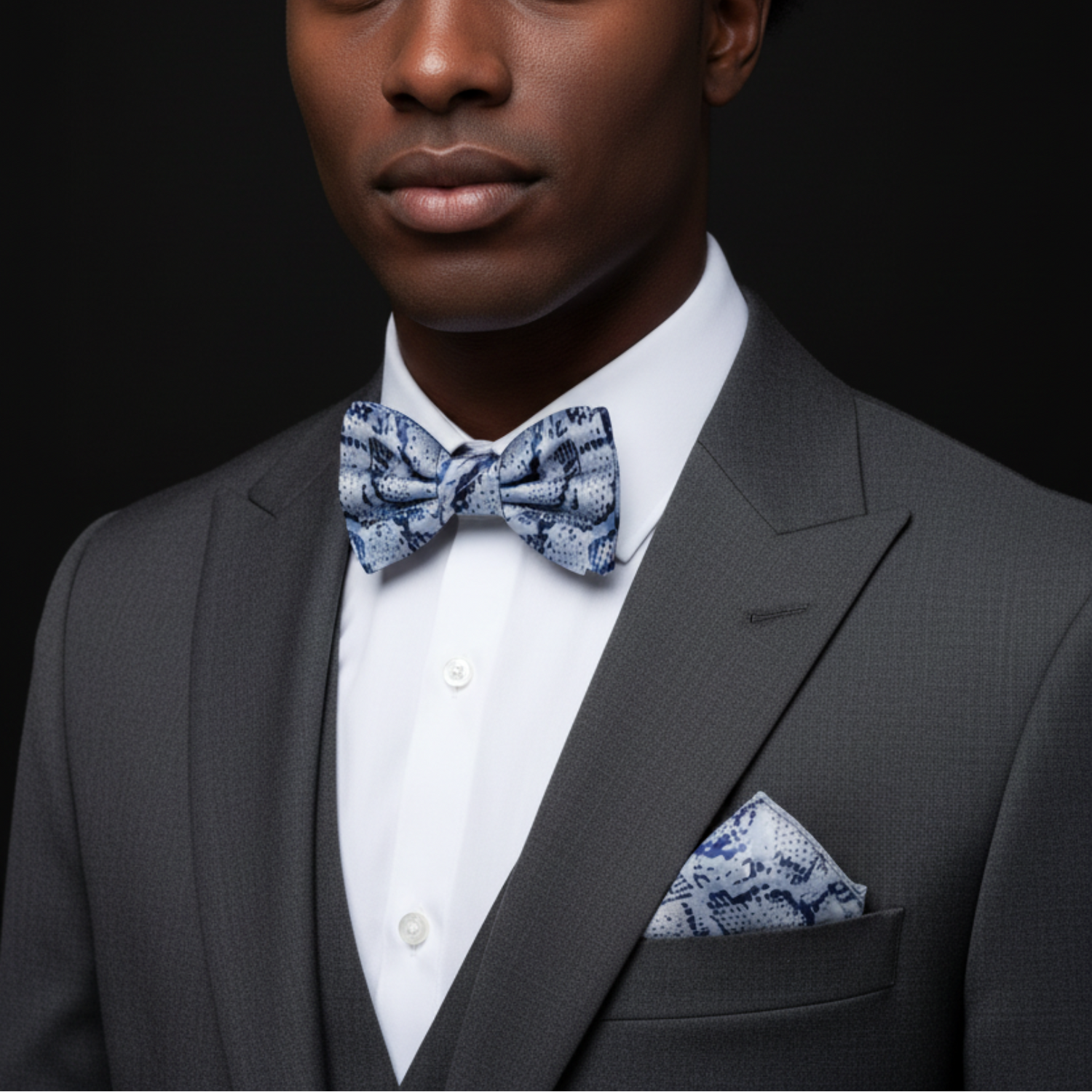 Grey snakeskin bow tie and square on man
