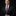 Man wearing orange black purple abstract tie and accenting stripe square