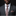 Man wearing a gray suit with a patterned tie and pocket square on a black background