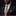 Man wearing a black suit with a coffee-themed tie and pocket square on a dark background