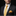 Man wearing a black suit with a yellow tie and pocket square on a dark background