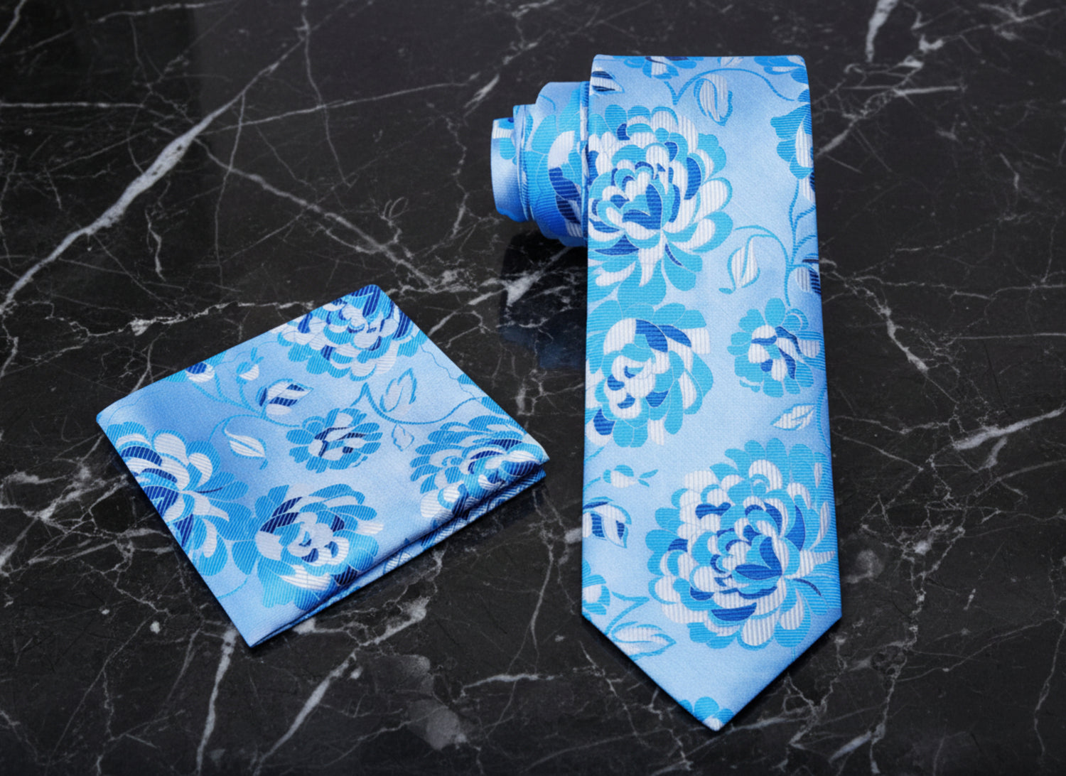 a blue floral necktie and pocket square