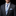 Man wearing a gray suit with a blue plaid tie and pocket square on a black background