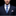 Man wearing a dark suit with a blue patterned tie on a black background