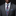 Man wearing a gray suit with a colorful paisley tie and pocket square on a black background