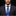 Man wearing a dark suit with a blue striped tie and purple pocket square on a black background