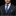 Man wearing a dark suit with a blue striped tie and pocket square on a black background
